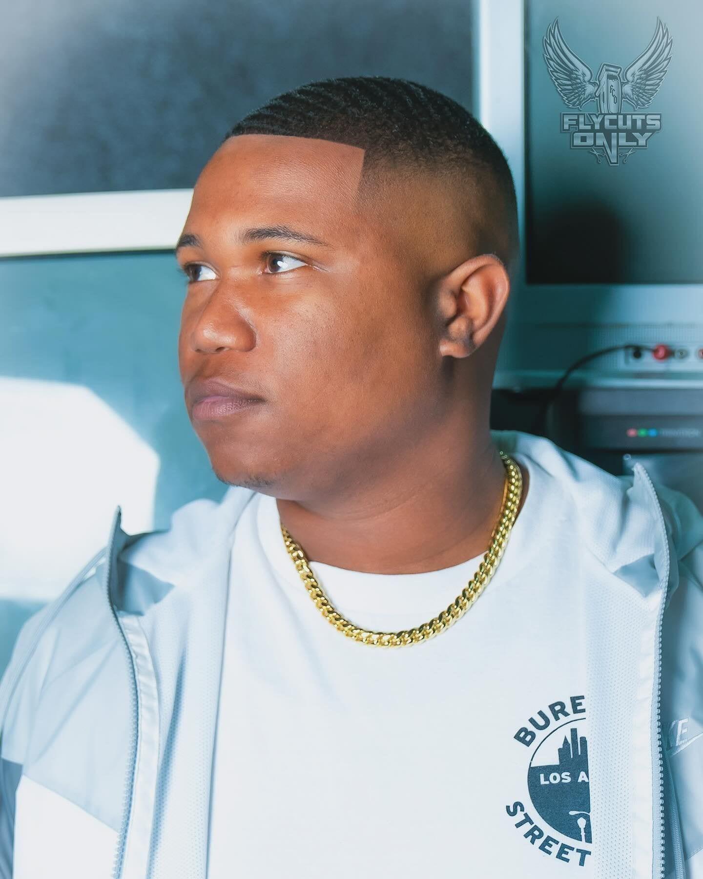 Client portrait after a taper, gold chain, natural light