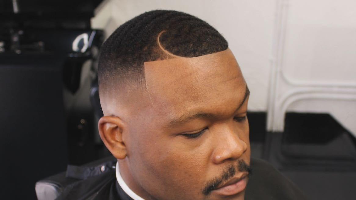 Macro of a fresh razored hairline with a curl design