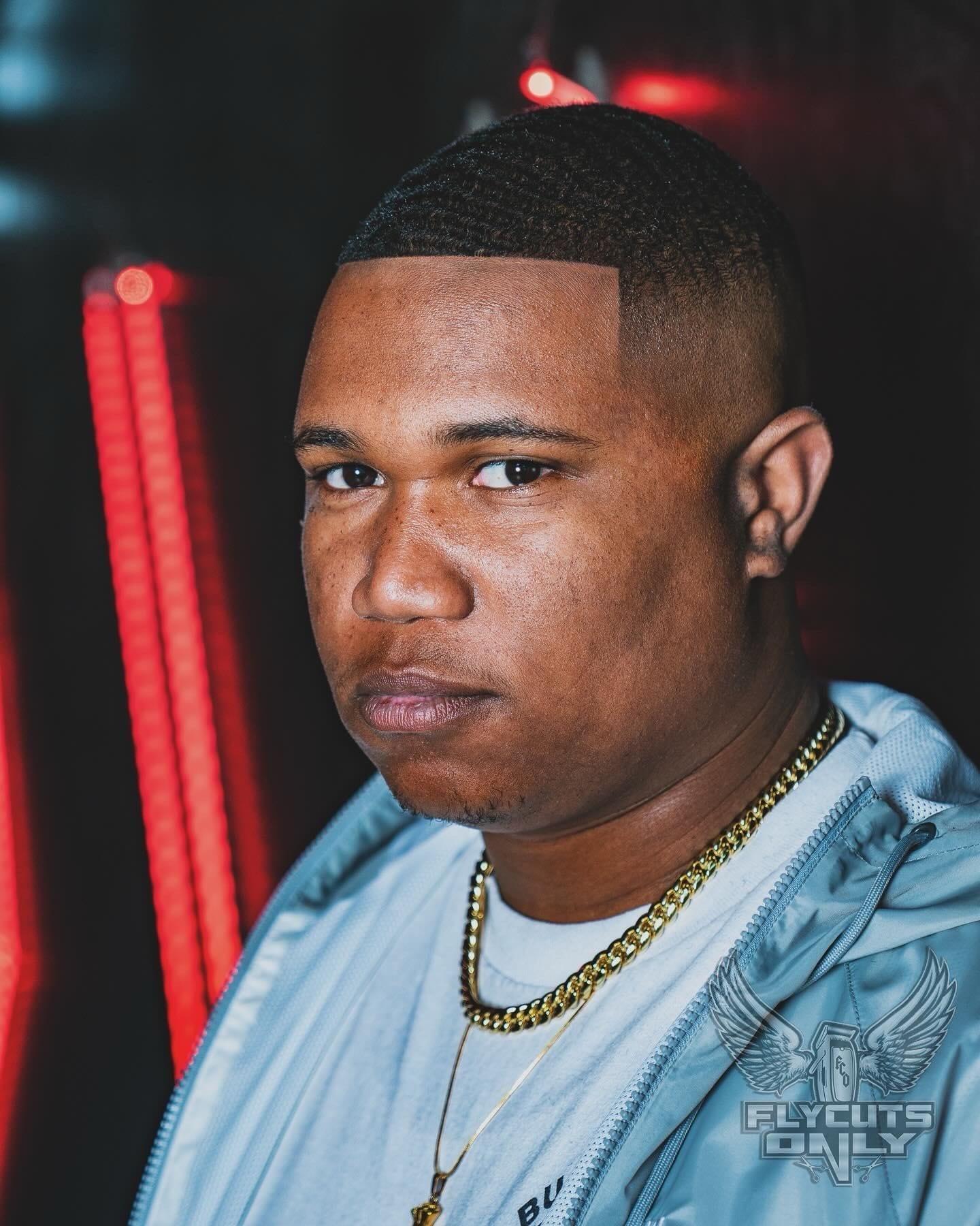 Client portrait under red neon after a line up at FLYCUTS0NLY